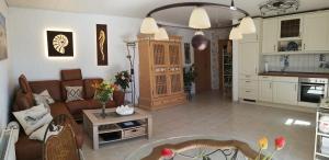 ein Wohnzimmer mit einem Sofa und einer Küche in der Unterkunft Ferienwohnung Libelle in Burhave