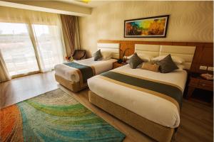 Pickalbatros Aqua Blu Sharm El Sheikh客房内的一张或多张床位