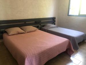 Postel nebo postele na pokoji v ubytování Résidence U LATONU - Palombaggia