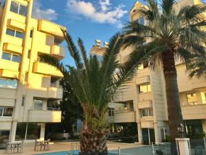 two palm trees in front of a building at Rumana Hotel in Anamur