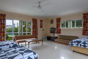 a living room with two beds and a couch at Ambleside in Port Shepstone +41 photos