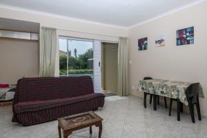 a living room with a couch and a table at Ambleside in Port Shepstone