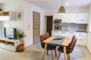 a kitchen and dining room with a table and chairs at Fonda Apartments in Koper