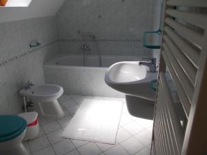a bathroom with a sink and a tub and a toilet at Anna villa in Lenti +44 photos