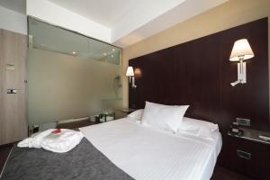 Postel nebo postele na pokoji v ubytování Hotel Salymar