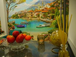 a table with a painting of a river and boats at Hotel Maravillas del Mundo in Calpe