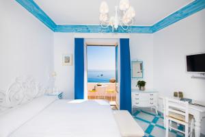 a bedroom with a bed and a view of the ocean at Villa Flavio Gioia in Positano