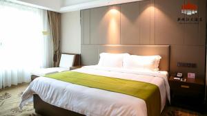 a hotel room with a large bed and a window at New Pearl River Hotel in Guangzhou