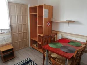 a room with a table and chairs and a closet at Domek letniskowy Mauritius in Mielno