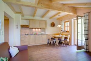 a kitchen and dining room with a table and chairs at Parggenhof in San Candido