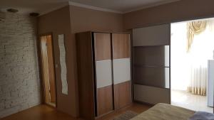 a bedroom with a large wooden cabinet and a window at Apartments Roko Kolinda in Bibinje