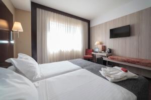 Postel nebo postele na pokoji v ubytování Hotel Salymar