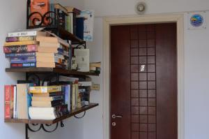 a book shelf filled with books next to a door at Paleochora Elizabeth Apartments in Palaiochora