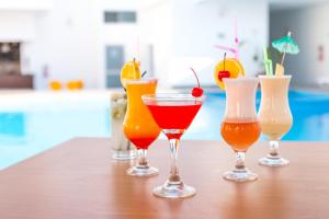 a group of four cocktails sitting on a table at Cumbaza Hotel & Convenciones in Tarapoto