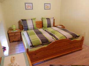 a bedroom with a wooden bed and a night stand at Ferienhaus Greta in Malborn