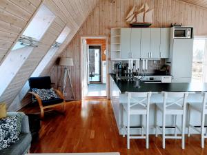 a kitchen with a island in the middle of a room at Kuvågen 23 in Vågenes