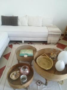a living room with two tables and a couch at Surf And Soul Morocco in Oualidia