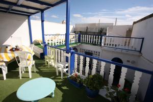 a balcony with a blue railing and a table and chairs at Riad Terre d'Azur in Essaouira