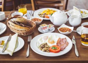 a table with plates of breakfast food on it at Jagniatkowa Koliba in Jelenia Góra-Jagniątków