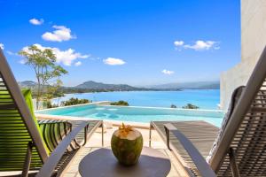 a view of the ocean from the deck of a villa at BEACHSIDE VILLA plus APARTMENT - AVA - at SUNSET COVE LUXURY VILLAS, 5 BED 5 BATH, Amazing SEA and MOUNTAIN VIEWS, only 100m walk to Swimming Beach in Bang Rak Beach