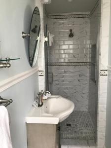 a white bathroom with a sink and a shower at Beauclaires Bed & Breakfast in Cape May +27 photos