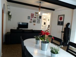 a living room with a table and a couch at Carmen Guest House in Benalmádena