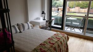 Postel nebo postele na pokoji v ubytování Lumiere Puerto Madero + 18 fotografií