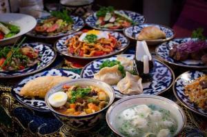 a table with many plates of food on at World Guest House in Samarkand