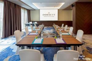 a conference room with a long table and white chairs at SKY POOL Luxury Suite 2-4Pax at KL City in Kuala Lumpur +28 photos