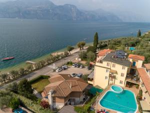 an aerial view of a villa with a swimming pool and the ocean at Residence Rosemary in Brenzone sul Garda