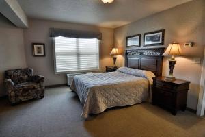 a bedroom with a bed and a chair and a window at Unit 312 1 Bd 1 Ba Condo Condo in Birchwood +6 photos