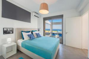 a bedroom with a bed with a view of the ocean at Luxury Villa Hera with Private Pool in Afantou