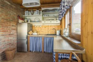 a kitchen with a sink and a refrigerator at Domek nad Odrą in Gryfino