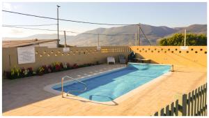 a swimming pool in a patio with mountains in the background at בית הכרם in H̱azon