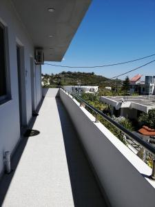 a walkway on a building with a view of the horizon at Paulsia Apartments in Psinthos