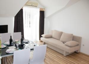 a living room with a couch and a table at Apartments Ankica in Šibenik