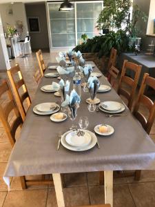a long table with plates and napkins on it at Le Blockhaus de Domléger et Spa in Domléger