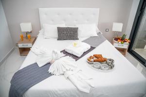 a large white bed with a tray of food on it at Infinity View Paradise Apartment in Arenales del Sol +36 photos