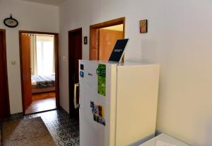 a white refrigerator with a laptop on top of it at Sobe Tivat in Tivat
