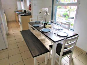 a kitchen with a table with chairs and a dining room at Home away from home in London