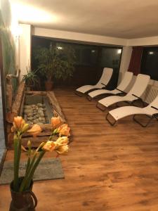 a room with a row of white chairs and a table at Hotel Gran Baita in Gressoney-Saint-Jean