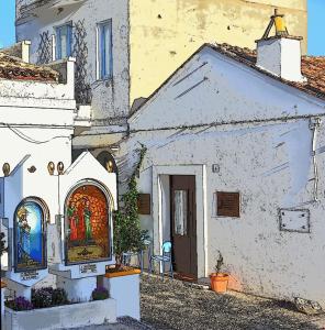 a painting of a white building with stained glass windows at ADRIANA in Pisticci