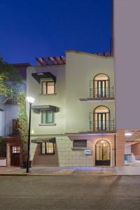 a large white building with two balconies on a street at Wyndham Garden Mexico Reforma in Mexico City