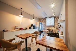 a kitchen and dining room with tables and chairs at Golden River Hotel in Gwangmyeong