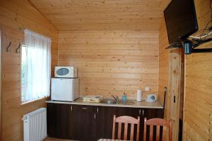 Cabaña de madera con cocina con fregadero y microondas en Domek 100 m od morza, en Jastarnia