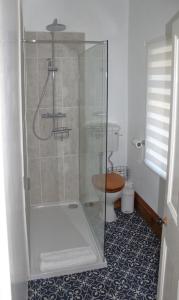 a bathroom with a glass shower with a toilet at Pickles Cottage in Barnoldswick