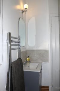 een badkamer met een wastafel en een spiegel bij Pickles Cottage in Barnoldswick