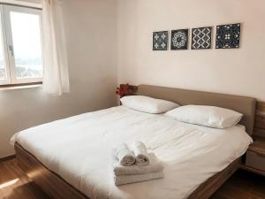 a bedroom with a bed with towels on it at Apartment Vrenjak in Portorož
