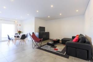 a living room with a couch and a table and chairs at Vitamin Sea, The Terrace Apartment in Baleal