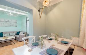 a dining room with a table and chairs and a couch at A33 Rhodes Old Town House in Rhodes Town